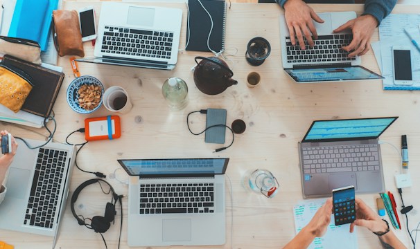People collaborating around laptops
