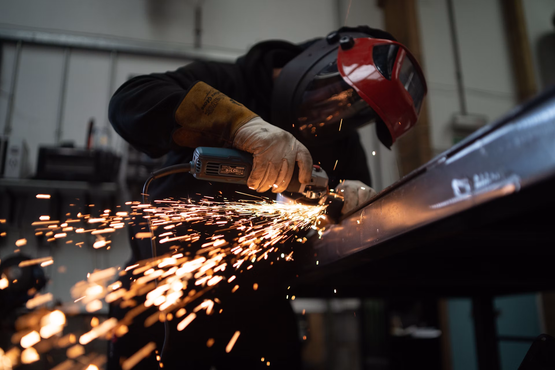 Person working with wood in a fabrication workshop
