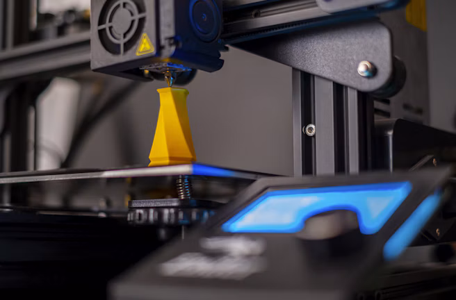 Close-up of a fabrication machine with blue light